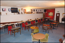 Photograph of the social club interior showing the seate area and flat screen TV